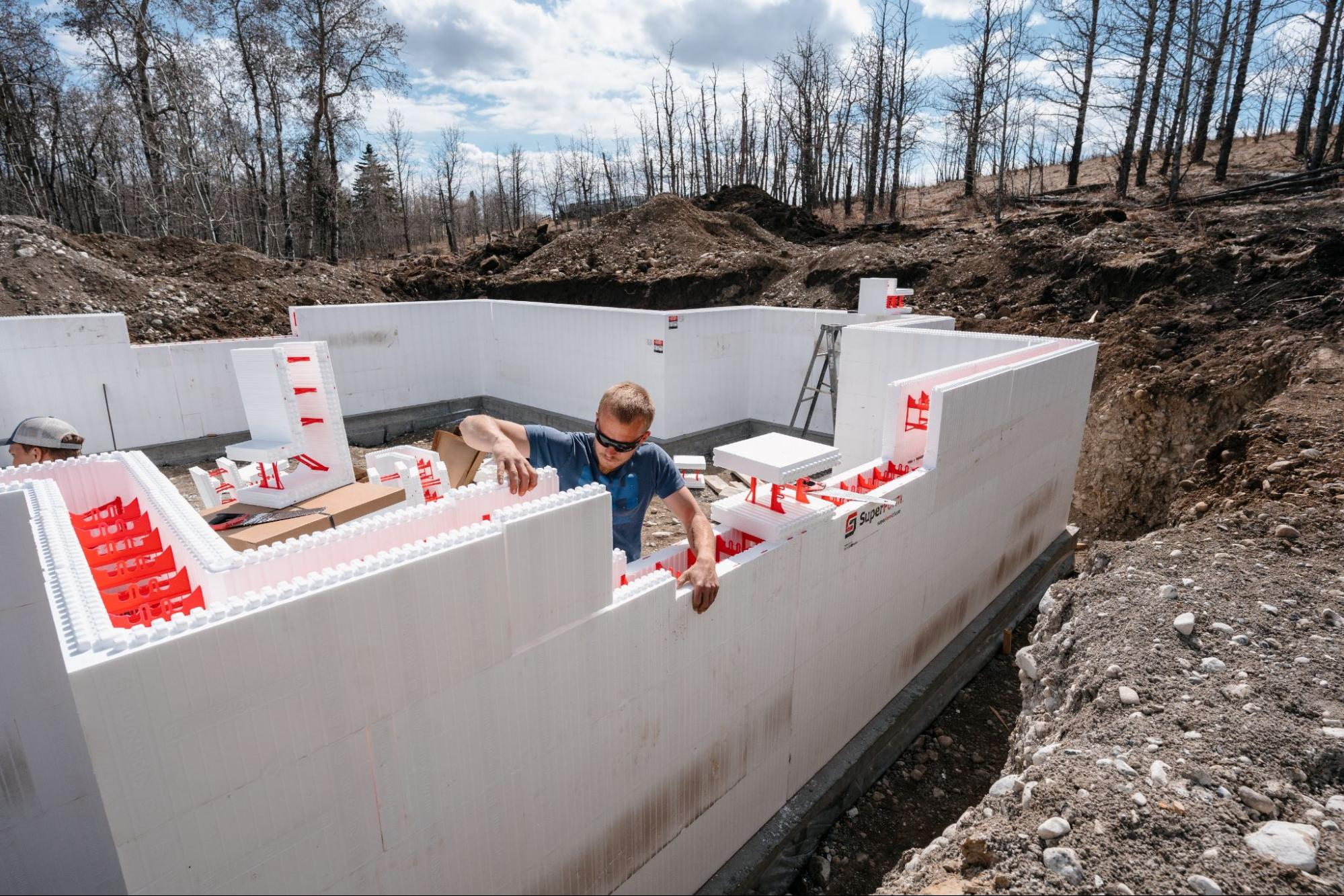 Contractor installing SuperForm ICF blocks at an active residential jobsite